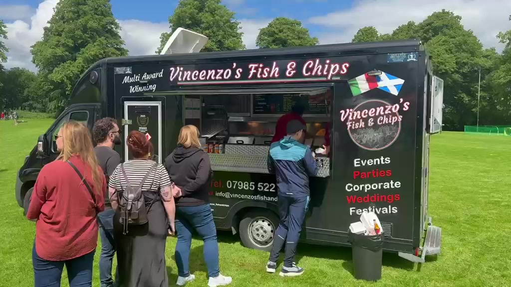 A real customer queue at the little black van